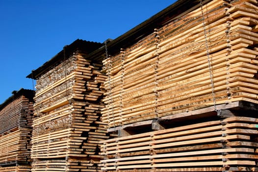 Stacks of lumber tiles in a factory