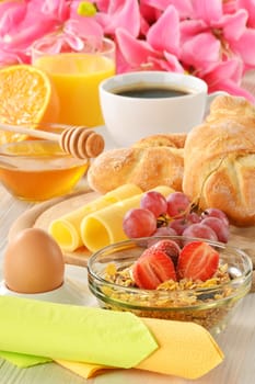 Breakfast with coffee, rolls, egg, orange juice, muesli and cheese