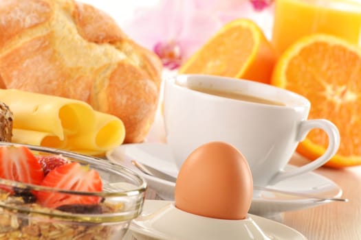 Breakfast with coffee, rolls, egg, orange juice, muesli and cheese