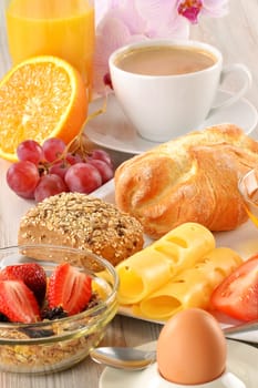 Breakfast with coffee, rolls, egg, orange juice, muesli and cheese