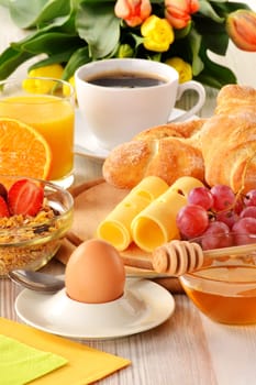 Breakfast with coffee, rolls, egg, orange juice, muesli and cheese