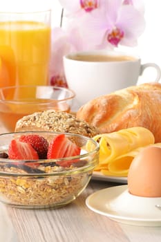 Breakfast with coffee, rolls, egg, orange juice, muesli and cheese