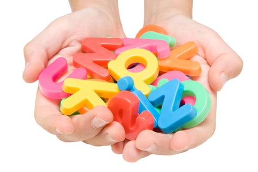 child hands with color alphabet . isolated on white.