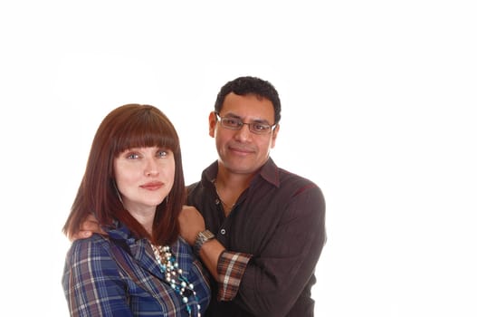 A closeup shoot of a mixed couple, Hispanic and Caucasian, she with red hair, blue shirt and necklace, standing for white background.