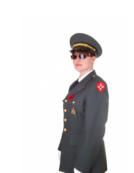 A tall woman in an military uniform and sunglasses standing in the studio with white cloves for white background.