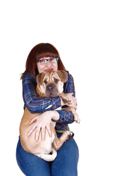A pretty lady in her forties, with red hair having her sharpei dog on her lap and giving him a big hug, for white background.