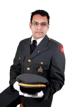 The portrait of a security guard sitting and holding his cap with white cloves and a uniform jacket, for white background.