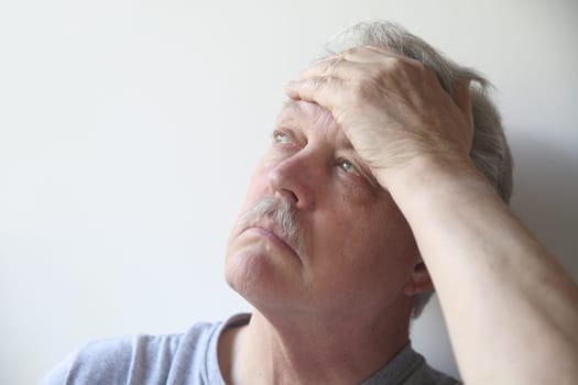 an older man with a terrible headache