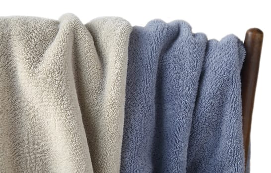 pale green and blue towels draped over an old wood chair