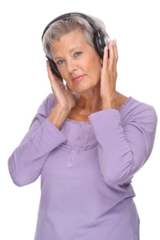 Studio shot of active and happy senior woman wearing headphones