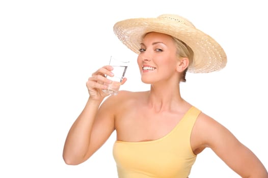 Studio shot of a young woman with a straw hat and a glass of water