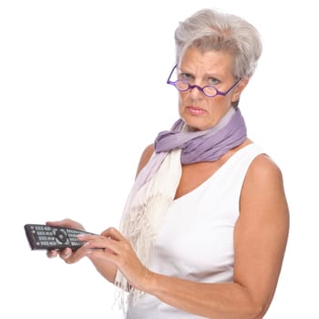 Studio shot of an active senior woman with remote control