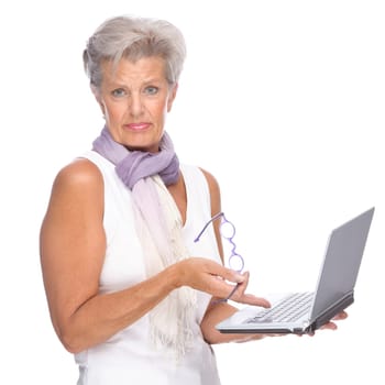 Studio shot of an active senior woman using a notebook