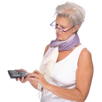 Studio shot of an active senior woman with remote control