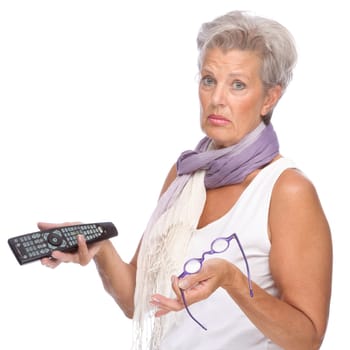 Studio shot of an active senior woman with remote control