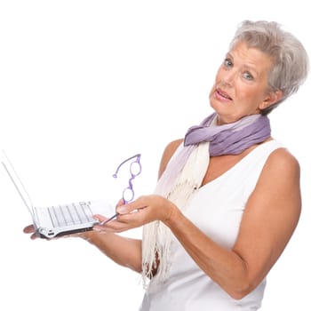 Studio shot of an active senior woman using a notebook