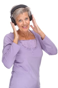Studio shot of active and happy senior woman wearing headphones