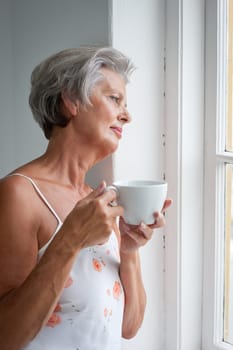 Active senior woman in the morning with a cup of coffee