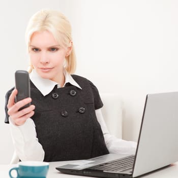 Young businesswoman sitting at desk with computer