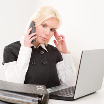 Young businesswoman sitting at desk with computer