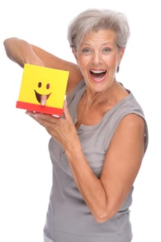Studio shot of an active senior woman with a box