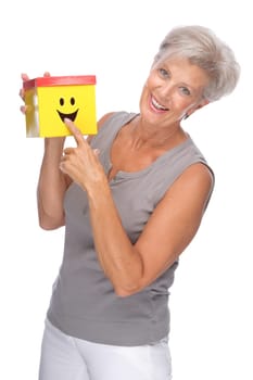 Studio shot of an active senior woman with a box