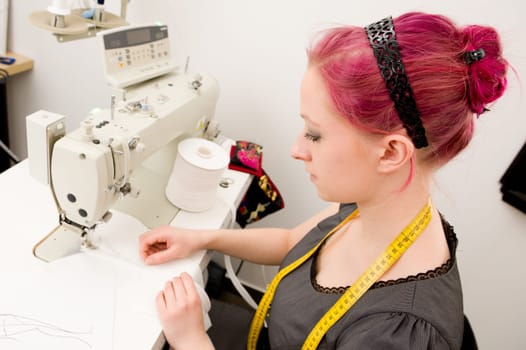 Young seamstress working on a sewing machine