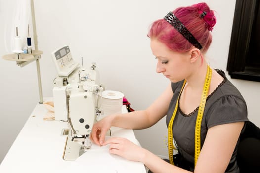 Young seamstress working on a sewing machine