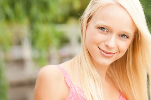 Portrait of a young and smiling woman in the park