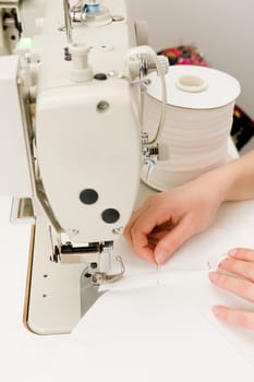 Young seamstress working on a sewing machine