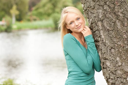 Portrait of a young and smiling woman in the park