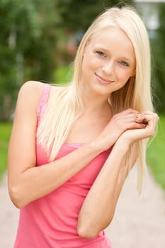 Portrait of a young and smiling woman in the park
