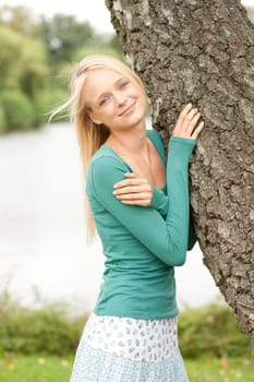 Portrait of a young and smiling woman in the park