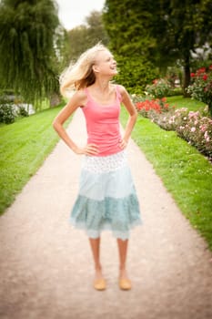 Portrait of a young and smiling woman in the park