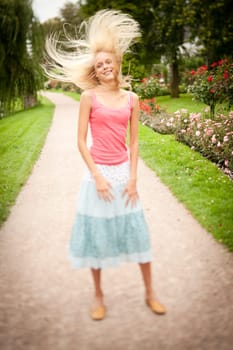 Portrait of a young and smiling woman in the park