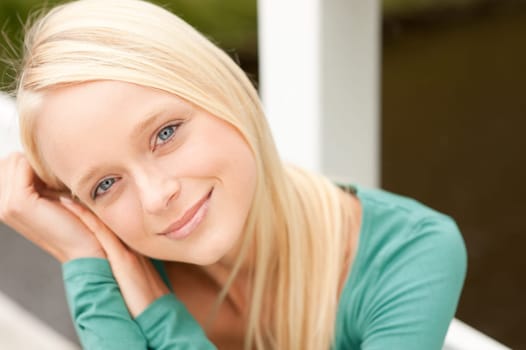 Portrait of a young and smiling woman in the park