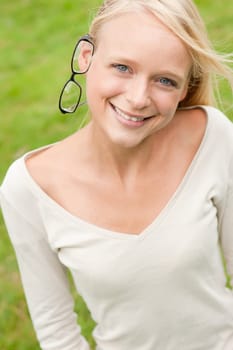 Portrait of a young and smiling woman in the park