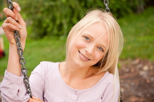 Portrait of a young and smiling woman in the park