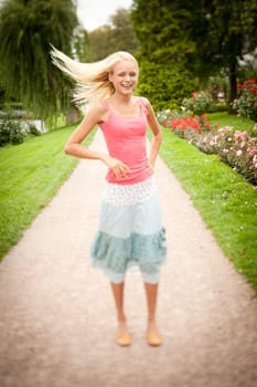 Portrait of a young and smiling woman in the park