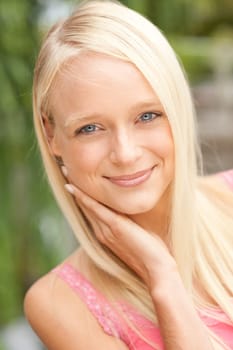 Portrait of a young and smiling woman in the park