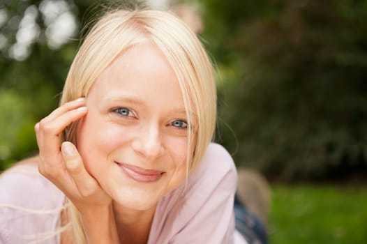 Portrait of a young and smiling woman in the park