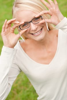Portrait of a young and smiling woman in the park
