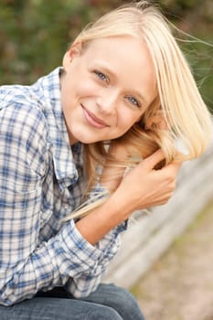 Portrait of a young and smiling woman in the park