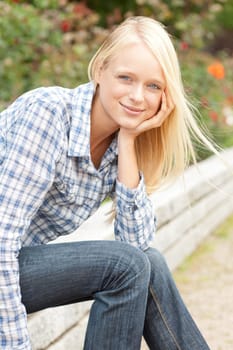 Portrait of a young and smiling woman in the park