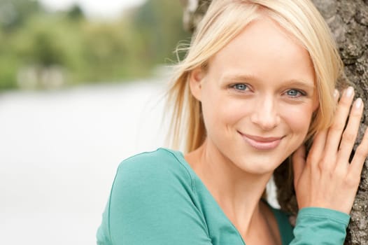 Portrait of a young and smiling woman in the park
