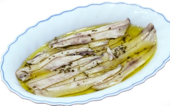 a pile of anchovies in vinegar isolated on a white background