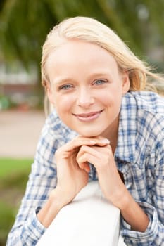 Portrait of a young and smiling woman in the park