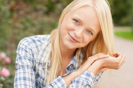 Portrait of a young and smiling woman in the park
