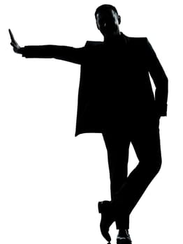 one caucasian business man silhouette standing Full length in studio isolated on white background