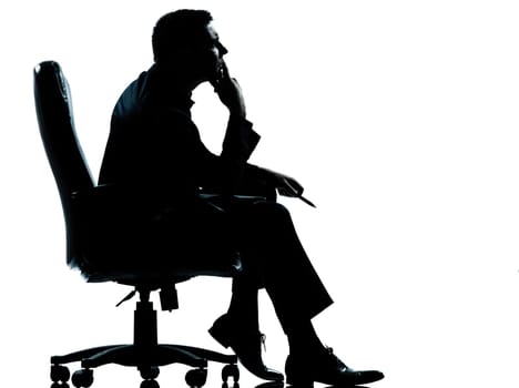 one caucasian business man sitting in armchair silhouette Full length in studio isolated on white background
